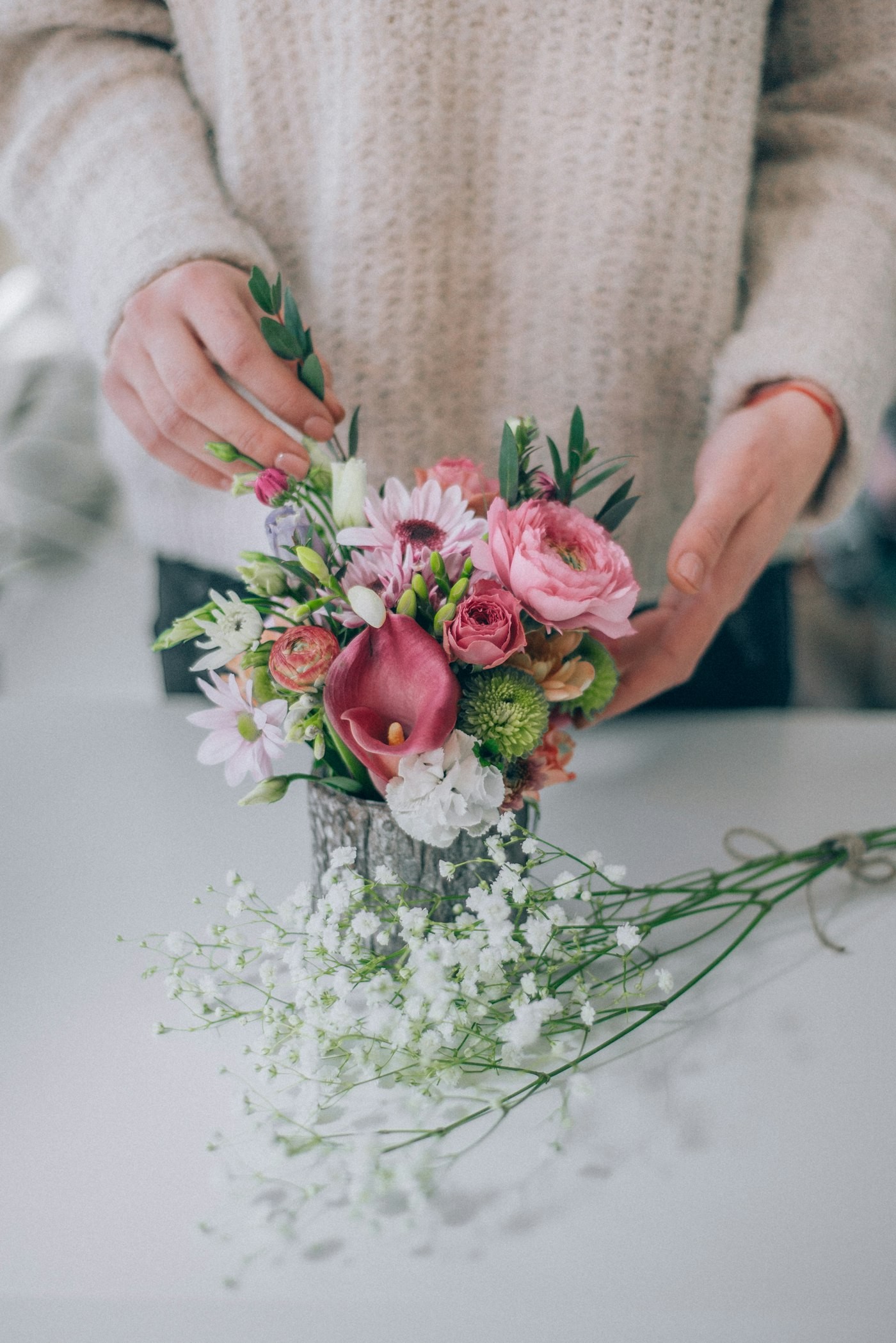 Florist hands arranging a fresh bouquet